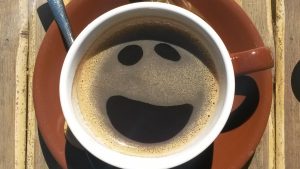 Coffee with a smile in the foam illustrating a better working life